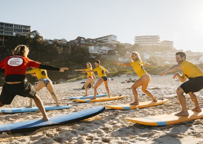 Adults enjoying a learn to surf experience with Manly Surf School at Freshwater Beach