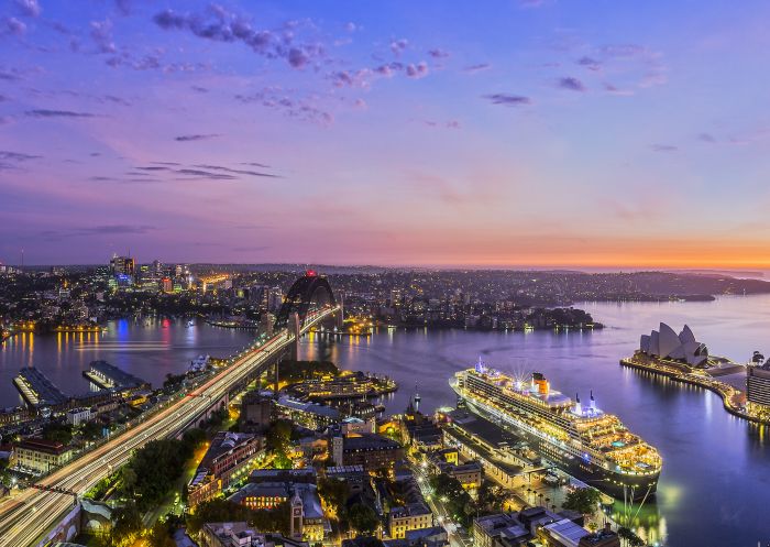 Sun rising over Sydney Harbour Sun rising over Sydney Harbour with Queen Mary II docked at the Overseas Passenger Terminal