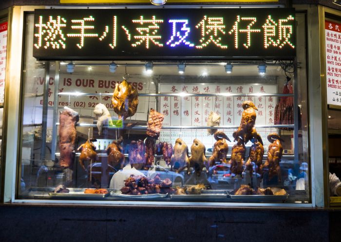 BBQ and roasted duck hanging in a restaurant window in Chinatown, Sydney