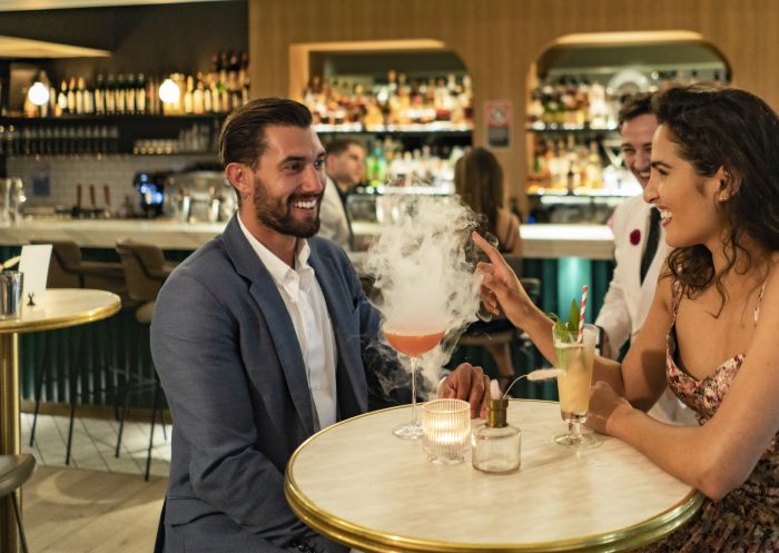 Couple enjoying drinks at Maybe Sammy cocktail bar in The Rocks