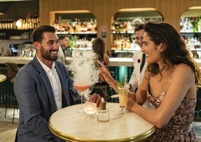 Couple enjoying drinks at Maybe Sammy cocktail bar in The Rocks