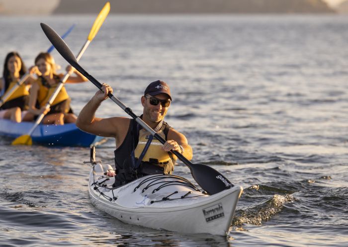 People enjoying a sunrise kayaking experience in Pittwater with Pittwater Kayak Tours, Palm Beach
