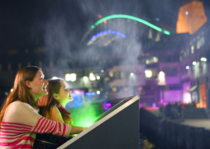 Mother and daughter interacting with The Laser Harp during Vivid Sydney at Walsh Bay, Sydney City