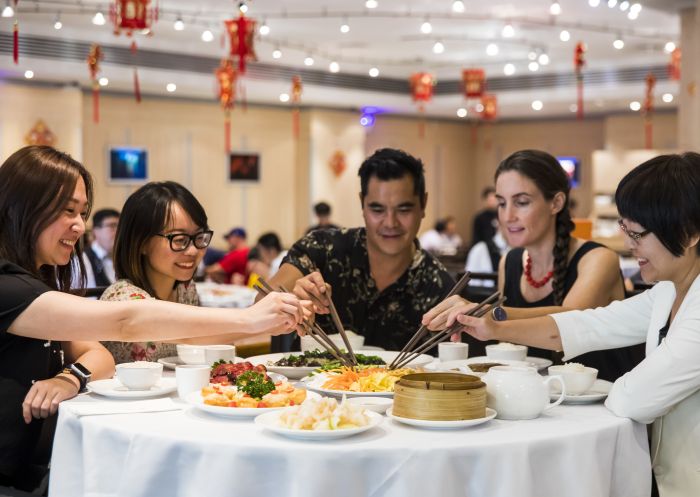 Friends enjoying a prosperity toss at Golden Century Restaurant, Chinatown during Chinese New Year 2018