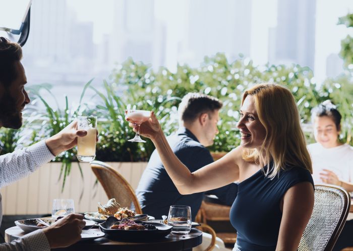 The Butler, Potts Point Patrons enjoying food and drink with city skyline views at The Butler restaurant, Potts Point