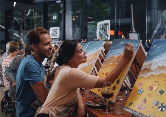 Couple enjoying a paint and sip session at Cork and Chroma, Surry Hills