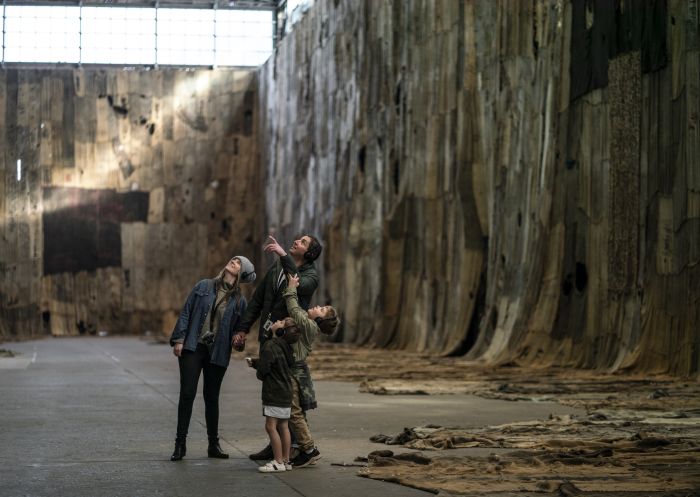 Family enjoying a self-guided audio tour on Cockatoo Island in Sydney Harbour.