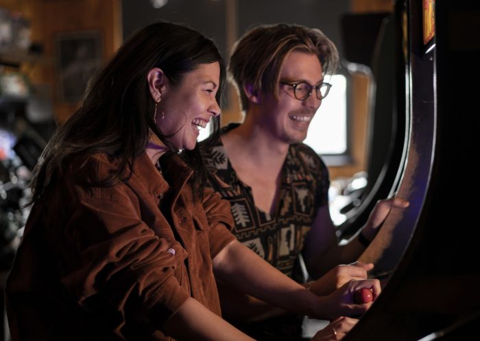 Couple playing arcade games at 1989 Arcade Bar, Newtown