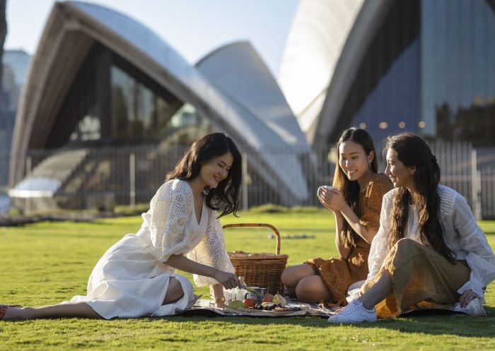 Friends enjoying a picnic in the Royal Botanic Garden, Sydney City