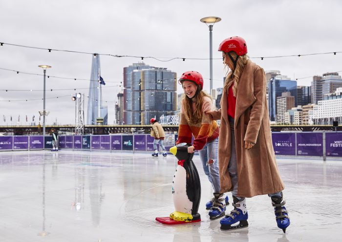 Mother and Daughter enjoying a winter ice skating session in Darling Harbour, Sydney City