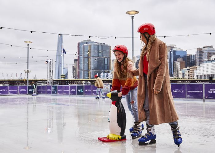 Family enjoying a winter ice skating session in Darling Harbour, Sydney City