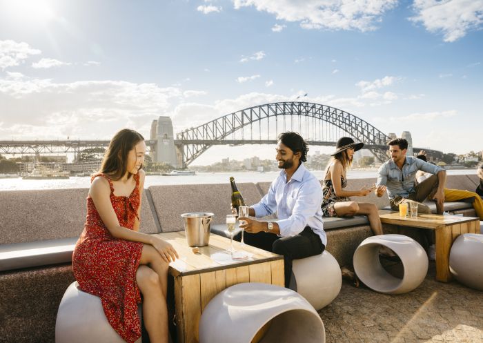 Couple enjoying champagne with harbour views at Opera Bar in Circular Quay, Sydney City