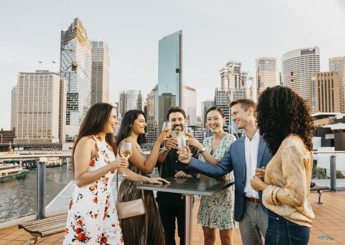 Friends enjoying rooftop drinks in The Rocks with views of Sydney Harbour, The Rocks