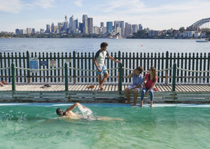 Students relaxing beside Maccallum Pool in Cremorne Point