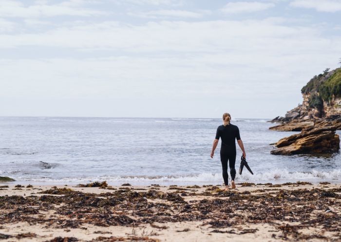 Man heading out for a snorkel at Gordons Bay, Coogee