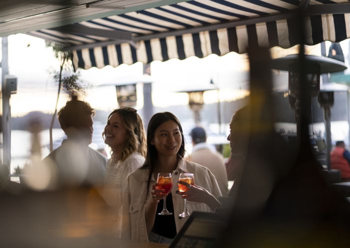 Friends enjoying a sunset drink at Watsons Bay Boutique Hotel's Beach Club, Watsons Bay