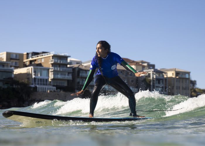 Woman enjoying a surf lesson with Lets Go Surfing, Bondi Beach