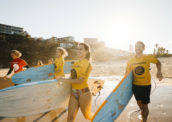 Adults enjoying a learn to surf experience with Manly Surf School at Freshwater Beach