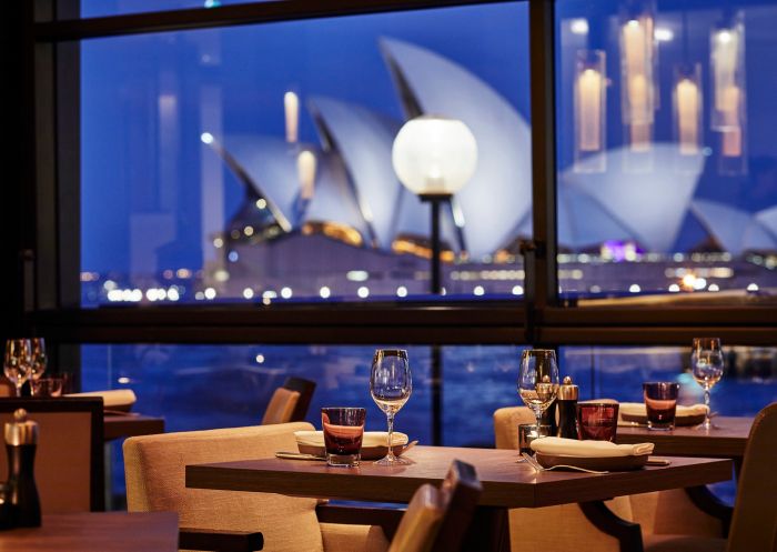 Dusk view of Sydney Opera House from floor-to-ceiling windows of The Dining Room restaurant
