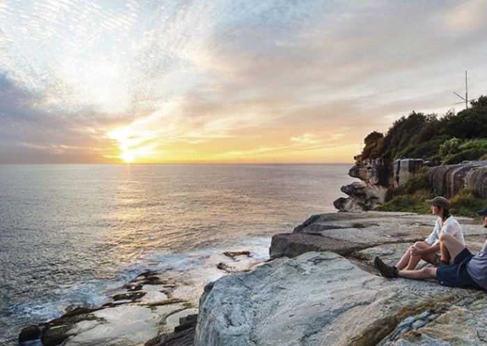 A couple enjoying the sunrise, Hornby Lighthouse at South Head, Sydney Harbour National Park. Photo: