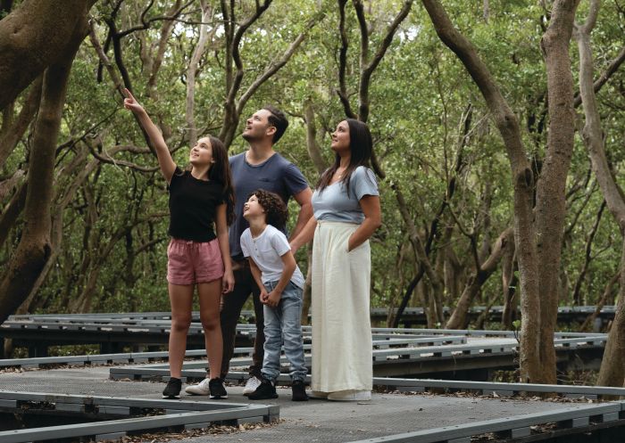 Family walking at Badu Mangroves in Sydney Olympic Park, Sydney West