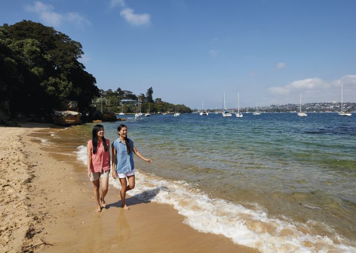 Friends enjoying a walk along Milk Beach on the Hermitage Foreshore Track, Vaucluse in Sydney