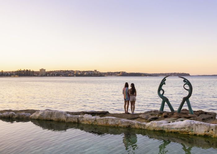 Couple relaxing by the water at Fairy Bower Pool, Manly