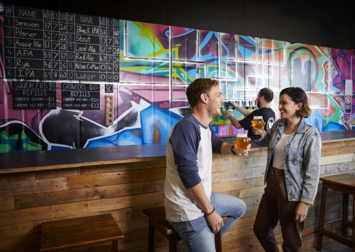 Couple enjoying a beer tasting session at Rusty Penny Brewing, Penrith