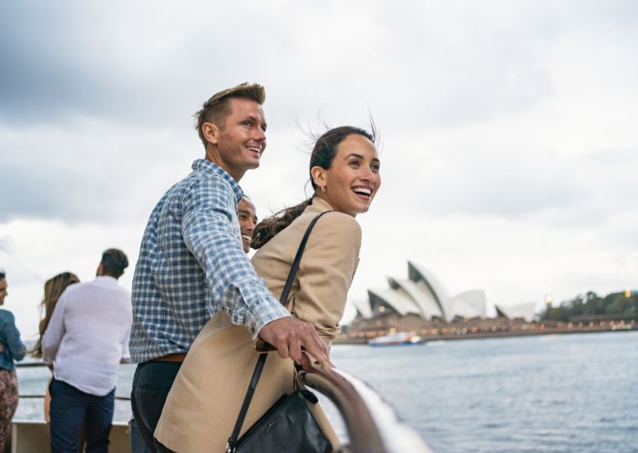 Couple enjoying harbour views aboard a Captain Cook Cruises vessel in Sydney Harbour