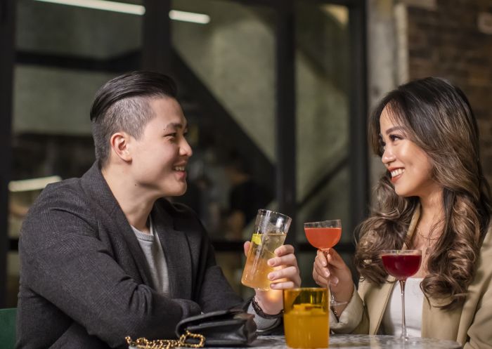 Couple enjoying cocktails at Re bar, Sydney