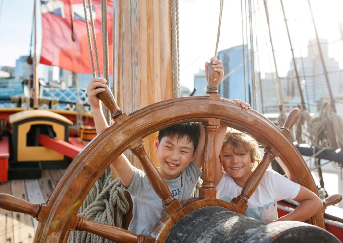 Kids at the wheel of the ship Endeavour in Australian National Maritime Museum, Darling Harbour