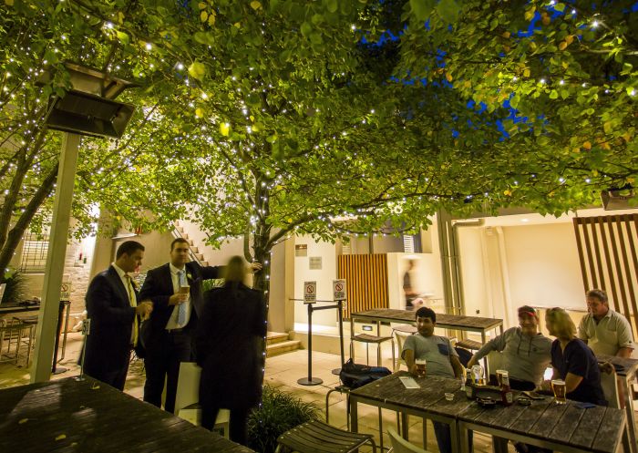 Patrons enjoying a drink in the courtyard of the Royal Hotel Randwick in Randwick, Sydney east