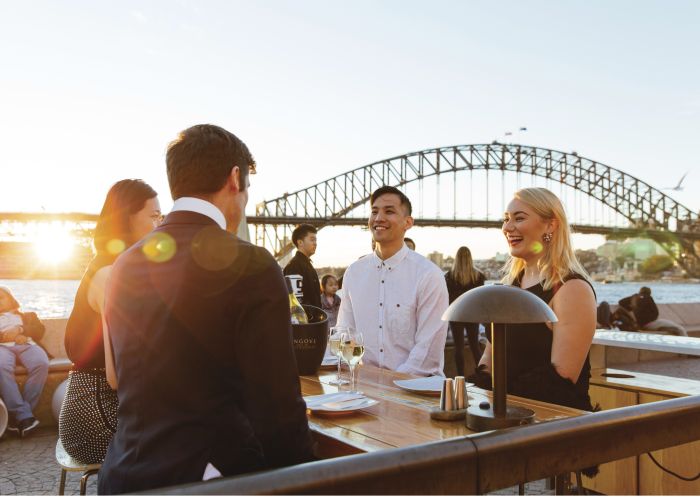 Friends enjoying drinks at sunset with views of Sydney Harbour Bridge and Sydney Harbour - Sydney Harbour -Sydney