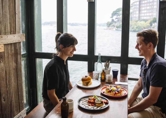 Couple enjoying food and drink at Celsius Coffee Co., Kirribilli