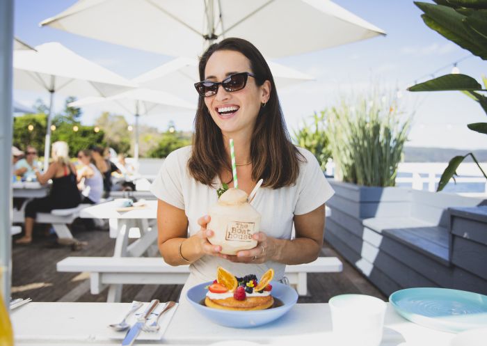 Woman enjoying food and drink at The Boat House, Palm Beach