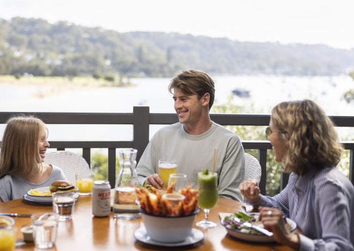 Family enjoying food and drink at The Newport, Newport with scenic views of Pittwater
