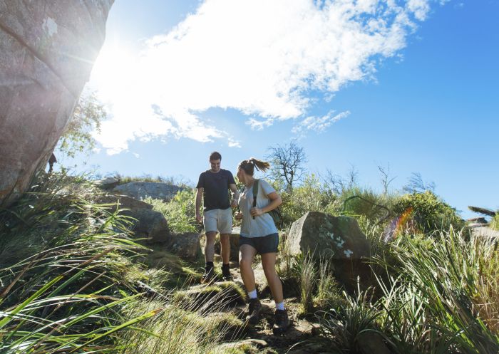 Couple enjoying a scenic coastal hike on the Barrenjoey Lighthouse Walk in Palm Beach, Sydney