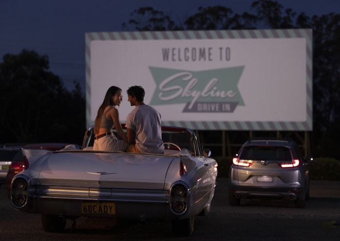 Couple sitting in their car ready to watch a movie at the Skyline Drive In Blacktown.