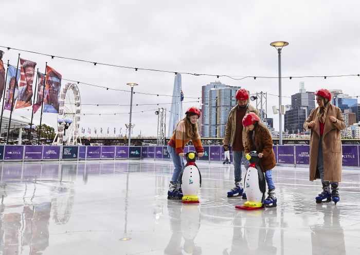 Family enjoying a winter ice skating session at Darling Harbour, Sydney