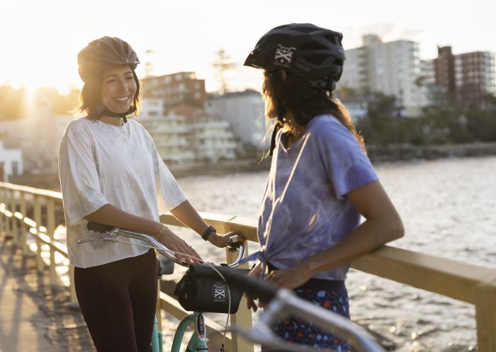 Friends enjoying an afternoon by the water on hired bikes from Manly Bikes, Manly