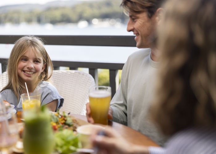 Family enjoying food and drink at The Newport, Newport with scenic views of Pittwater