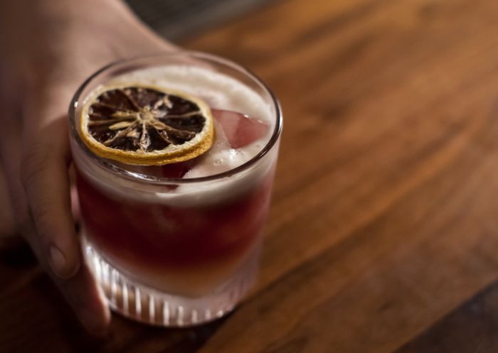 Bartender serving a cocktail at Esquire Bar and Bistro, Sydney City