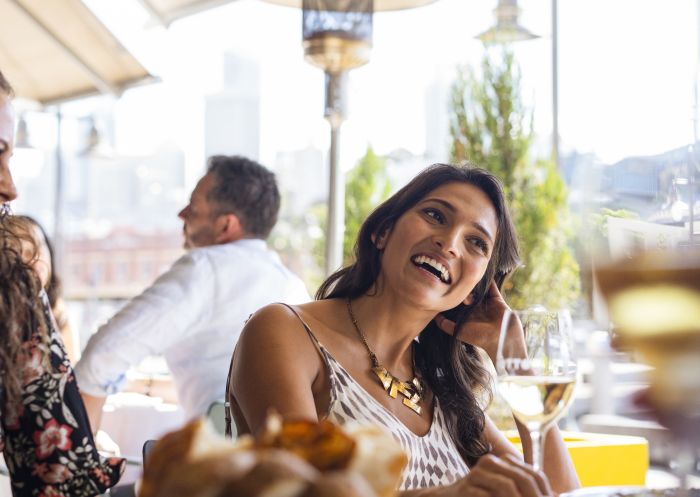 Friends enjoying food and drink at Otto Ristorante, Woolloomooloo