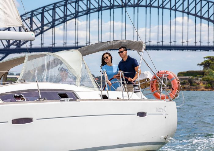 Couple enjoying harbour views from a chartered sailing vessel, Sydney Harbour