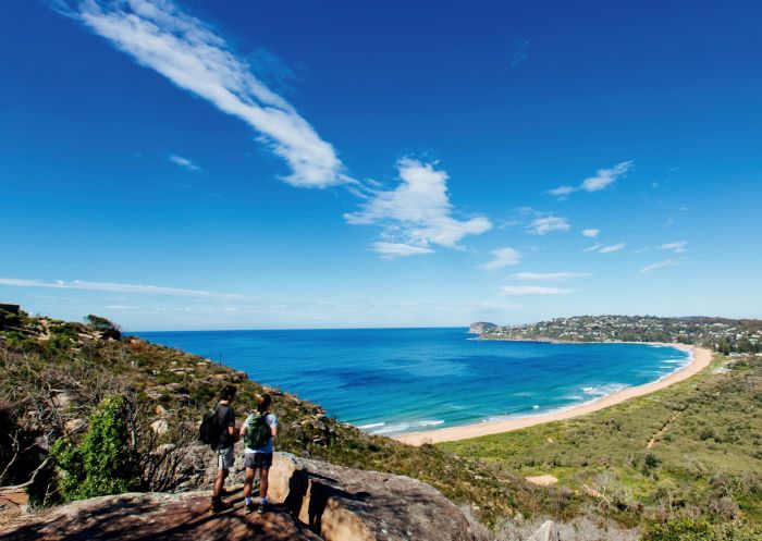 Couple enjoying a scenic coastal hike on the Barrenjoey Lighthouse Walk in Palm Beach, Sydney