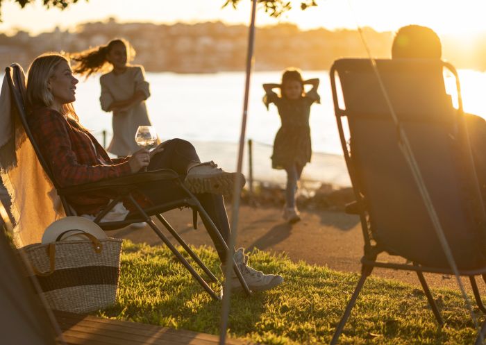 Family relaxing on Cockatoo Island's waterfront campground, Cockatoo Island 