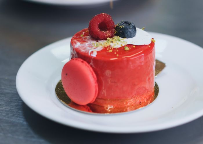 Chef placing the final touches on a dessert at La Renaissance Patisserie and Cafe, The Rocks