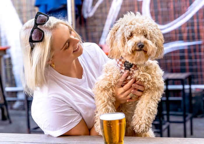 Woman with her dog in the courtyard at Vic on the Park, Enmore