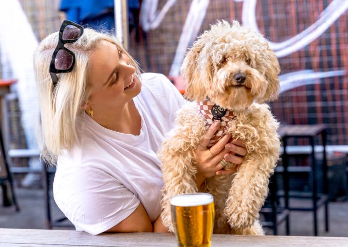 Vic on the Park, Enmore Woman with her dog in the courtyard at Vic on the Park, Enmore