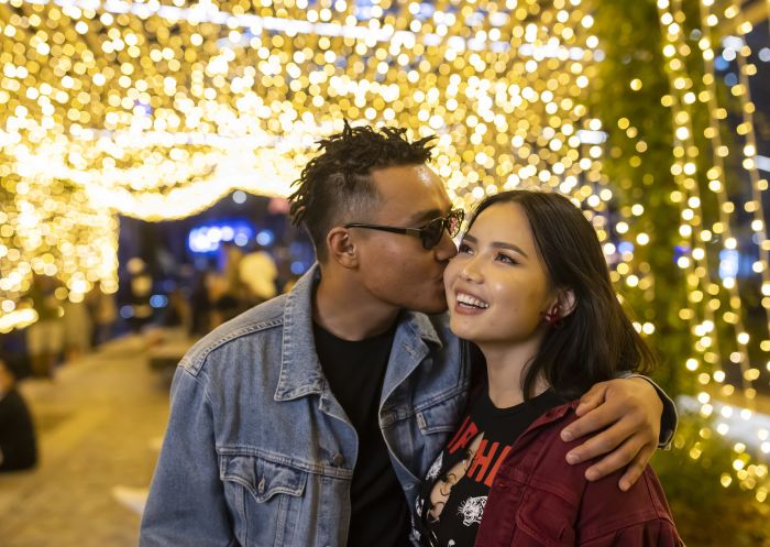 Couple under the Xmas lights at Christmas Socialisers 2021, Darling Harbour - Credit Anna Kucera